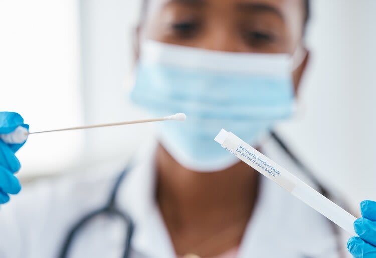 A doctor with a DNA sample and test tube.